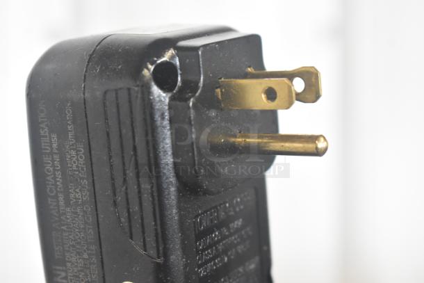 Close-up of a black power plug for a Bar Maid S48B35B04 A-200 Upright Bar Glass Washer, showing prongs and labeling.