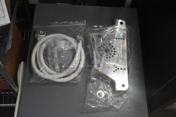 Brand new Avantco 177PBD3 cappuccino machine parts in packaging; includes hose and metal fittings.