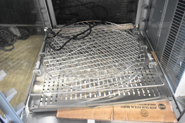 Brand new countertop warming display case, 115 volts, 1 phase, with minor scratches and dents, interior wire racks.