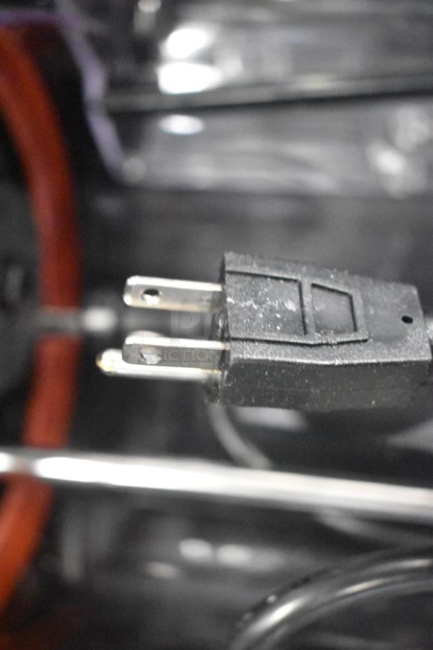 Close-up of a power plug, part of a Narvon 378RBD5G3 triple 5-gallon bowl refrigerated beverage dispenser.