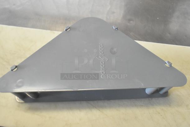 Gray triangular metal piece with "Robot Coupe" logo, new condition.