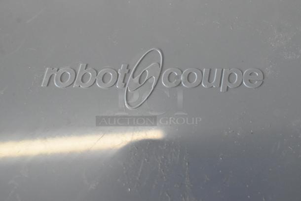 Robot Coupe item with embossed logo. Part of 13-piece auction set, including full-size aluminum bun pan. Brand new condition.