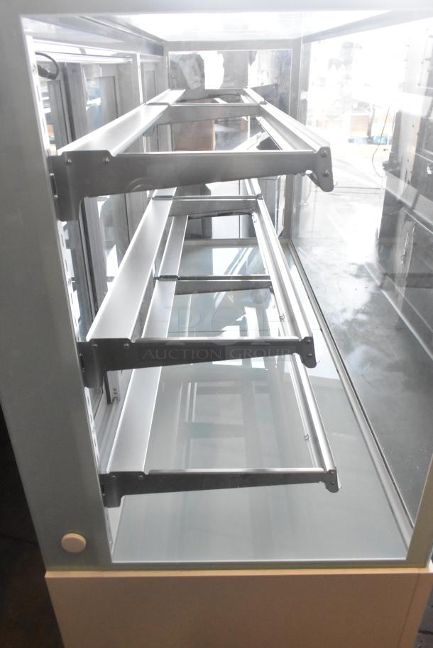 Brand new Avantco 193BCFD72W 70 7/8" white bakery display case, LED lighting, on casters, minor dents, 110-120V, 1 phase.