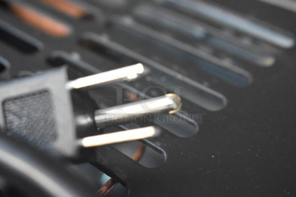 Close-up of a power plug for the Avantco 178SSUC48RHC cooler, showing metal prongs and a black casing.