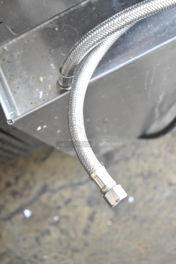 2016 Cleveland 24CGA10.2 steam cabinet part detail, showing braided stainless steel gas hose connection.