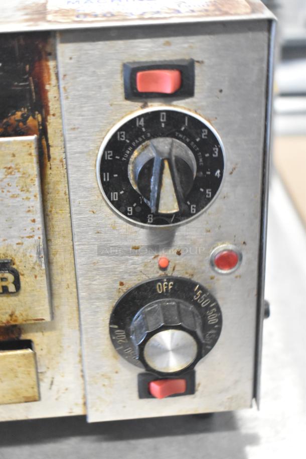 Star P012 countertop electric pizza oven close-up. Features temperature and timer dials, visible wear and rust. 120 Volts.