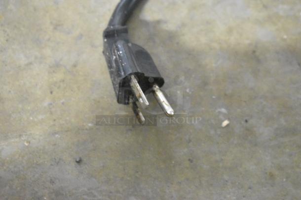 Close-up of a power plug for a Vollrath Cayenne COA 8004 convection oven, showing three metal prongs.