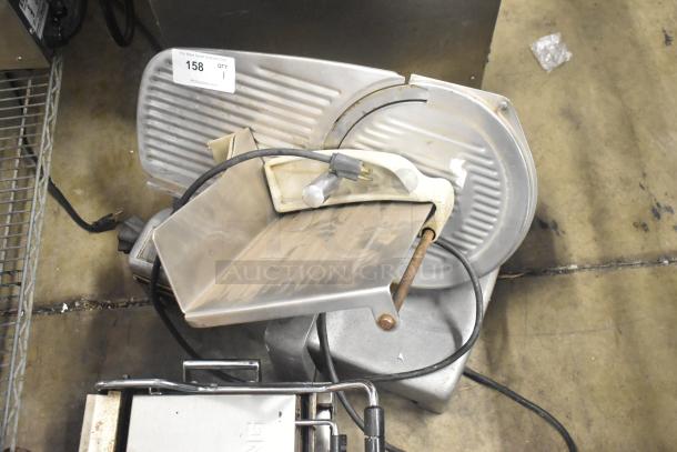 Hobart countertop meat slicer, 115 volts, 1 phase. Stainless steel finish, used condition with visible wear. Auction tag present.