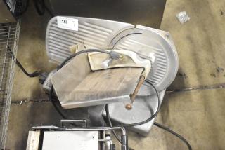 Hobart countertop meat slicer, 115 volts, 1 phase. Stainless steel finish, used condition with visible wear. Auction tag present.