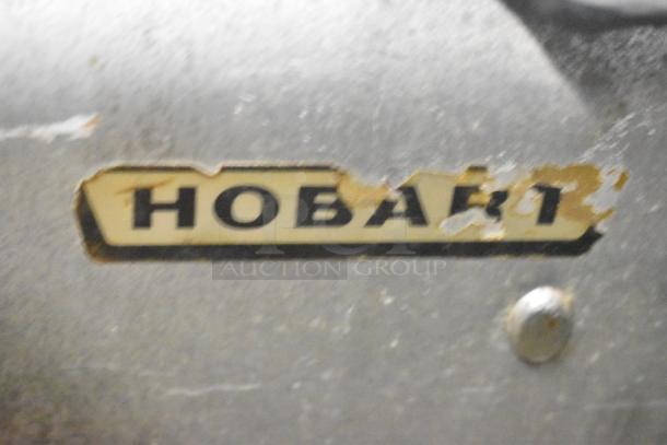 Hobart Countertop Meat Slicer with worn logo, 115 volts, 1 phase. Visible scratches on metal surface.