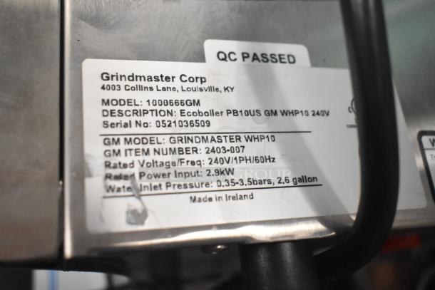 BRAND NEW Grindmaster 1000666GM PB10US stainless steel hot water dispenser, 240V. Label shows model details and QC passed.