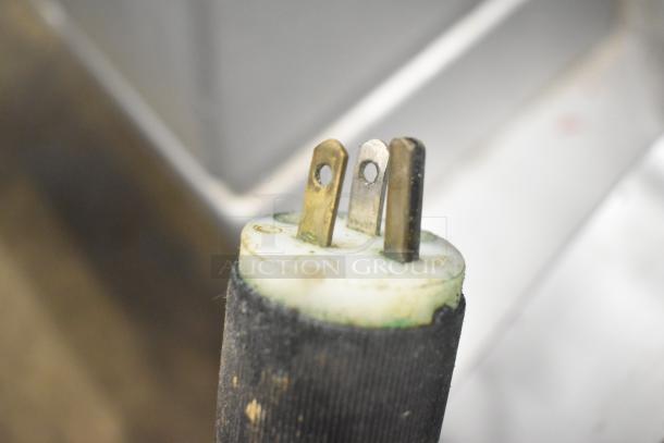 Close-up of a 115-volt plug from a Bizerba Commercial Countertop Meat Slicer Stacker.