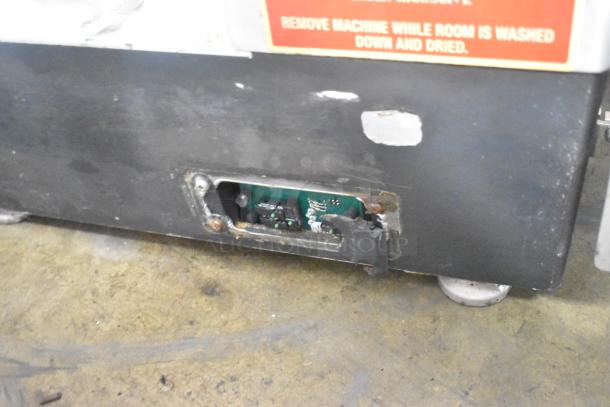 Bizerba commercial countertop meat slicer stacker, shows signs of wear. 115 Volts, 1 Phase. Label warns against use during cleaning.