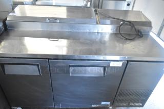 True TPP-60 commercial pizza prep table with stainless steel top, dual storage, and commercial casters. Model TPP-60, 115V, 1 phase.