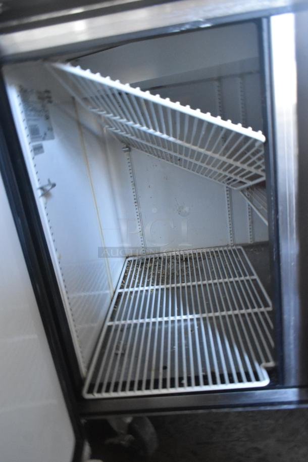 True TPP-60 Commercial Pizza Prep Table with shelving, on casters. Interior shows wear. 115 volts, 1 phase.