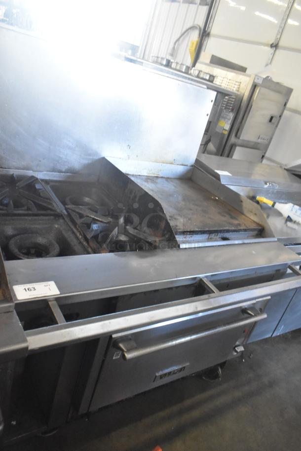 Vulcan commercial gas range with 4 burners, flat top griddle, oven, and casters. Missing 2 grates. Used condition.