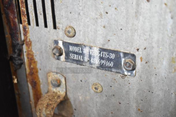 Vulcan gas range with 4 burners, flat top griddle, oven on casters. Model V2BC4TS-30, serial 481699460. Missing 2 grates.