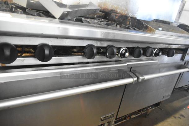 ThermaTek commercial gas range with 6 burners, flat top griddle, and 2 ovens. Stainless steel, visible wear, model label.