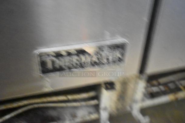 ThermaTek label on a commercial gas range with 6 burners, flat top griddle, and 2 ovens. Durable, ideal for high-volume use.