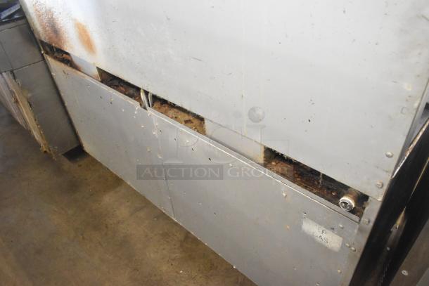 ThermaTek commercial gas range, 6 burners, flat top griddle, 2 ovens. Visible wear and rust, marked "GAS".