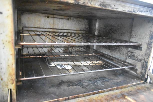 ThermaTek commercial oven interior with two wire racks, showing signs of use and wear.