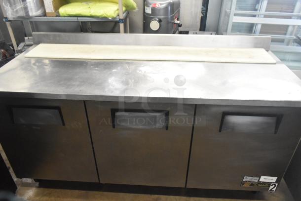 True TWT-72 commercial 3-door worktop cooler, stainless steel, on casters. 115 volts, 1 phase. Some wear visible.