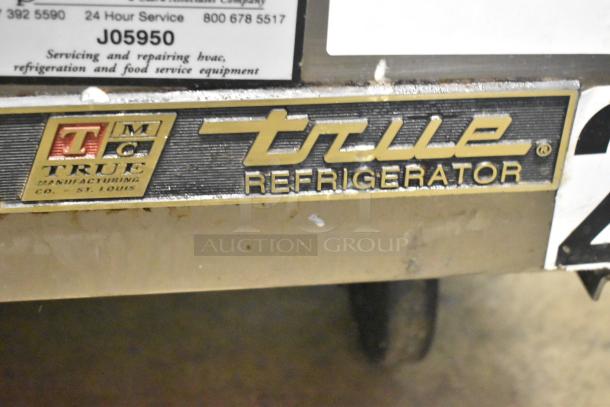 True TWT-72 commercial 3-door work top cooler, branded label visible, 115 volts, on casters, used condition.