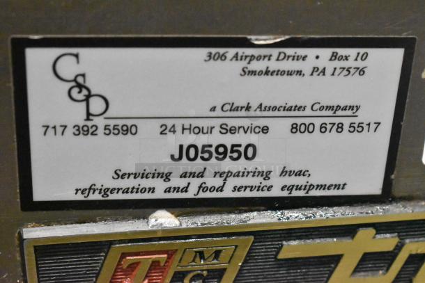 True TWT-72 Commercial 3 Door Cooler, 115V, 1 Phase, on casters. Label shows service info and Clark Associates branding.