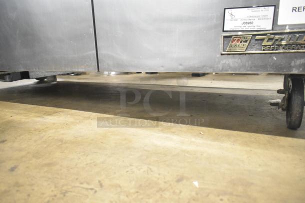 True TWT-72 commercial 3 door work top cooler, stainless steel, on commercial casters, with visible brand label.