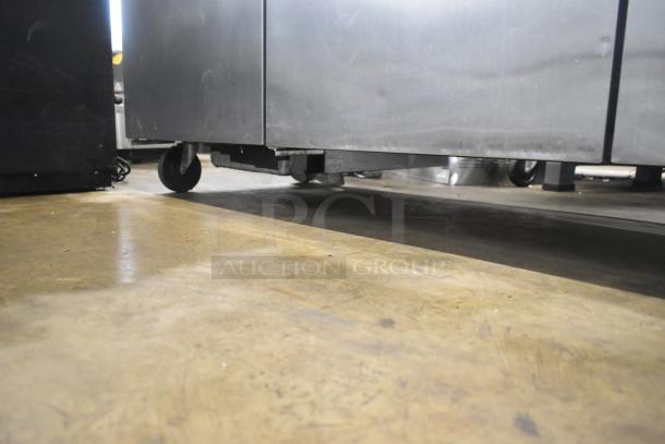 True TWT-72 Commercial 3 Door Work Top Cooler with casters, 115V, 1 Phase; stainless steel, on commercial casters.