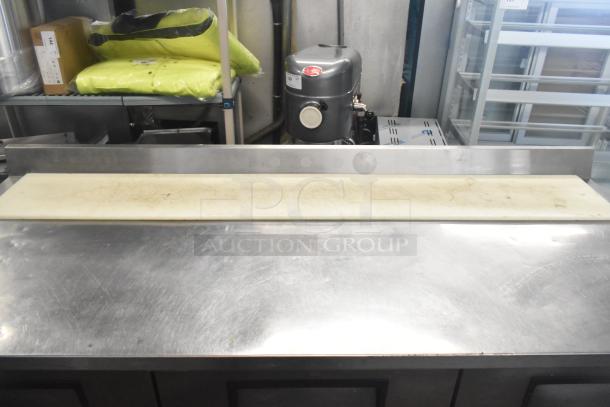 True TWT-72 commercial 3-door work top cooler with commercial casters, stainless steel, 115V, 1-phase, shows surface scratches.