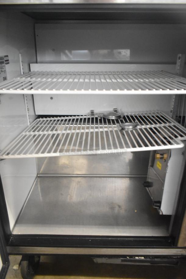 True TWT-72 commercial 3-door work top cooler with shelves, on casters, 115V, 1 phase, in good condition.