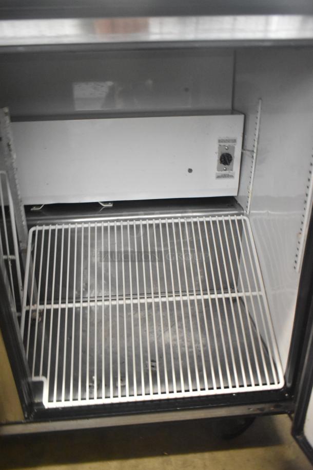 True TWT-72 commercial 3-door work top cooler on casters, 115 volts, shown interior with shelving, clean condition.