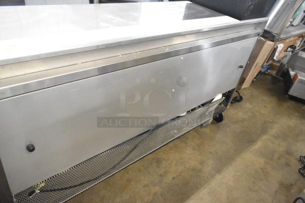 True TWT-72 commercial 3-door work top cooler with casters, 115 volts, 1 phase, stainless steel, visible wear.