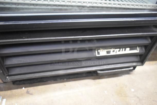 True GDM-12 commercial reach-in cooler, 115V, single door, solid construction, visible True logo, used condition.