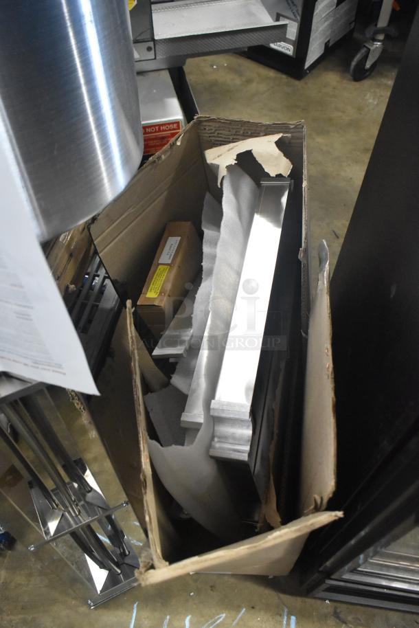 Brand new scratch and dent Robot Coupe R199 Robo-Cart in original packaging with visible cardboard box damage.