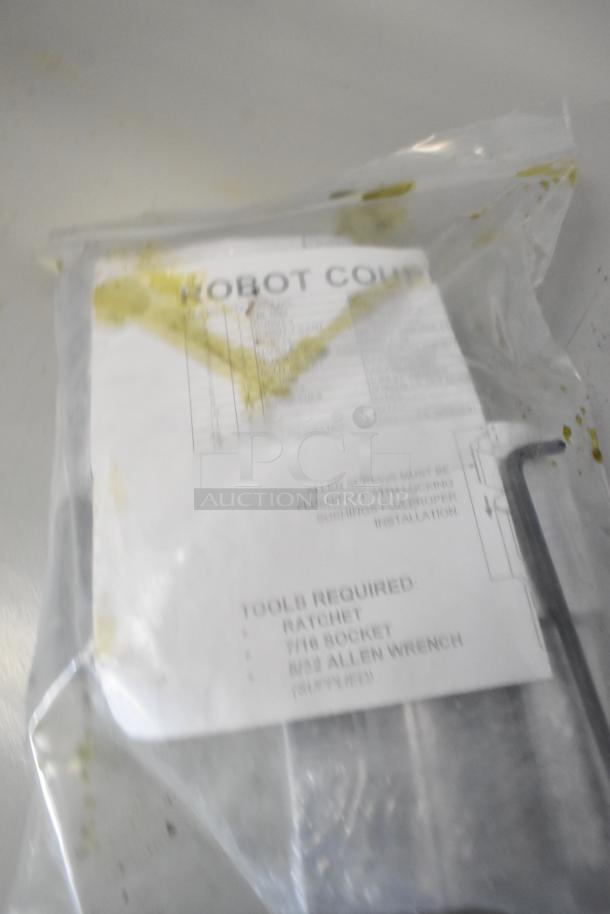 Brand new Robot Coupe R199 Robo-Cart in original packaging, labeled "Tools Required." Item shows minor scratches and dents.