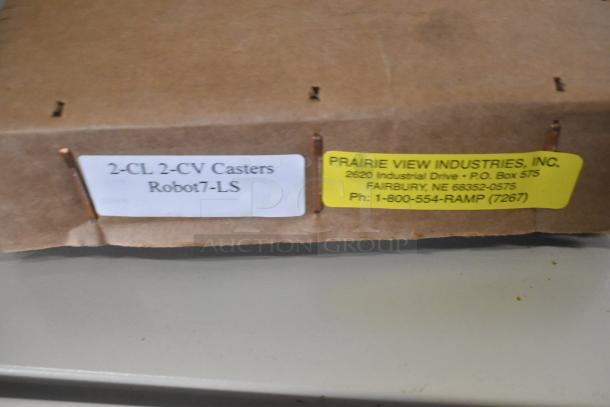 Cardboard box labeled "2-CL 2-CV Casters Robot7-LS" and "Prairie View Industries, Inc.," containing parts for Robot Coupe R199 Robo-Cart.