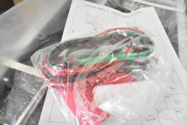 Brand new cart with minor scratches, includes assembly instructions, red and green cords, sealed in plastic packaging.