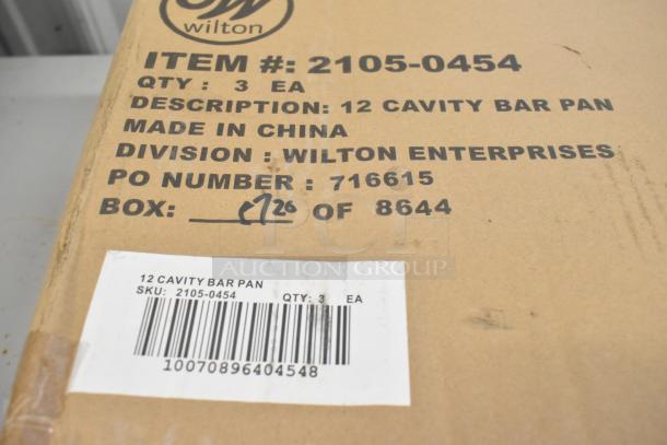 Box labeled "12 Cavity Bar Pan" with Wilton branding, item #2105-0454, contains 3 non-stick, steel brownie pans, 2 1/2"x2 1/2"x1 1/2".