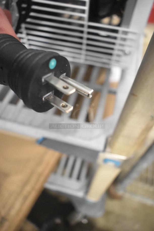 Plug of Summit ACR161W medical refrigerator, 115 volts, shown against shelving backdrop. Brand new, scratch and dent condition.