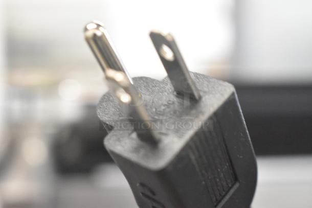 Close-up image of a black electrical plug, part of the 2023 Avantco 177PG200S Panini Sandwich Grill.