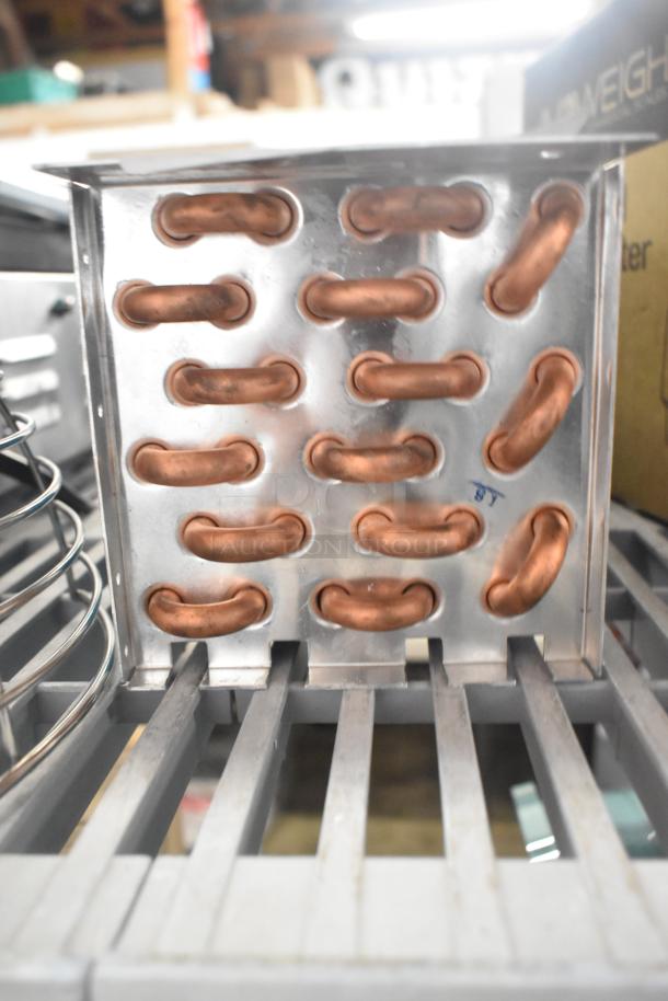 Brand new evaporator coil with visible copper tubing and minor scratches, ideal for HVAC systems.