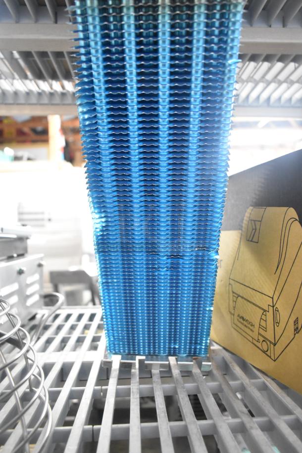 Brand new evaporator coil, scratch and dent condition, blue fins, metal grid base, ideal for HVAC systems.