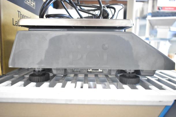 "Brand new AvaTek PCS40 40 lb. digital price computing scale, showing base and connectivity ports, legal for trade."