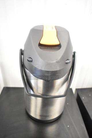Brand new Acopa Air Pot, stainless steel with scratches and dents. Features a black handle and orange lever.