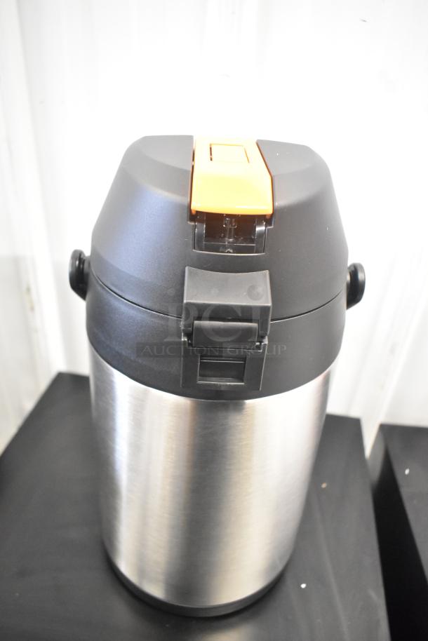 BRAND NEW Acopa Air Pot, stainless steel with minor scratches and dents, black lid with orange button.