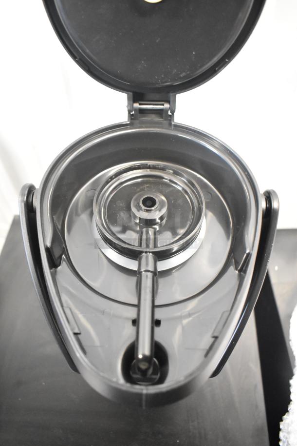 Brand new Acopa Air Pot, top view, showing interior and spout. Scratch and dent condition.