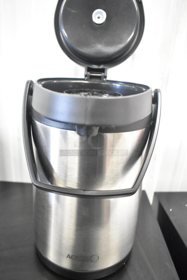 Alt text: Brand new Acopa Air Pot with minor scratches and dents, stainless steel, lid open, black handle, visible brand logo.