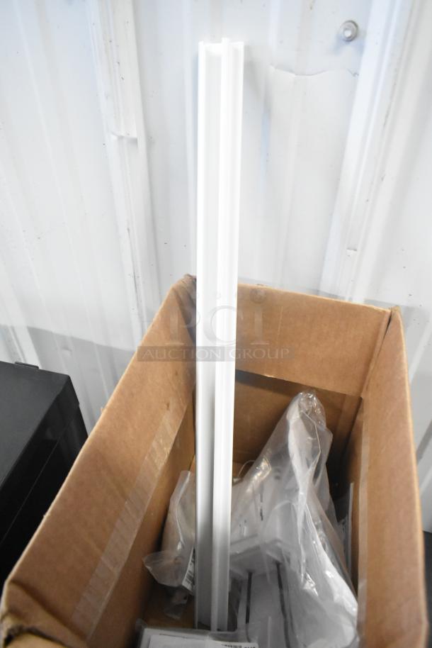 Box of new scratch-and-dent items including MainStreet Equipment 22" tag holder and other kit parts in packaging.